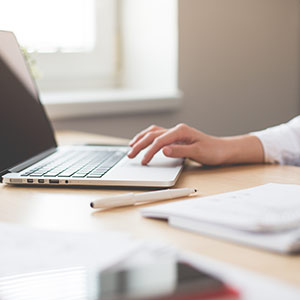 person working at their laptop on a desk