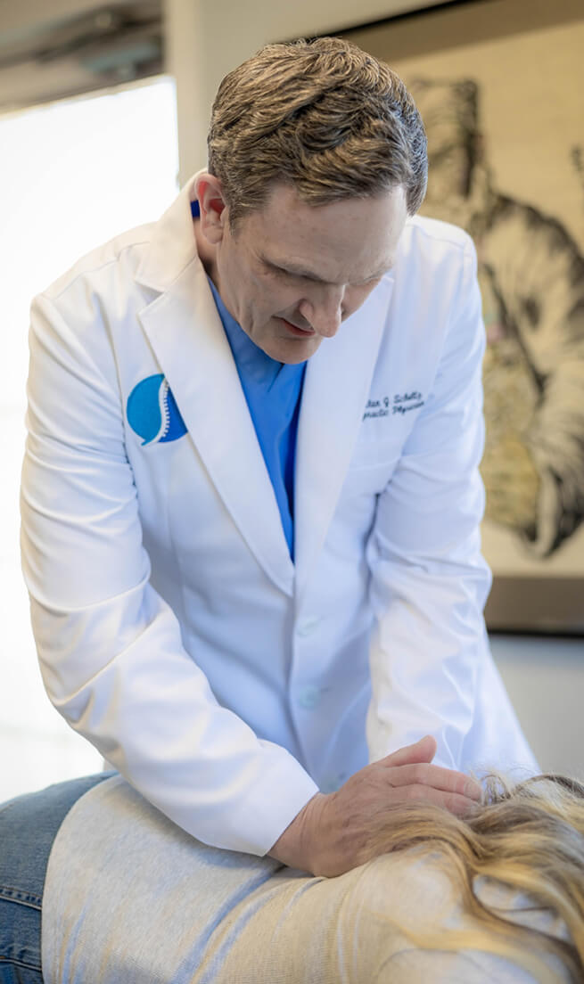 Johnston chiropractor Dr Schultz adjusting patients back