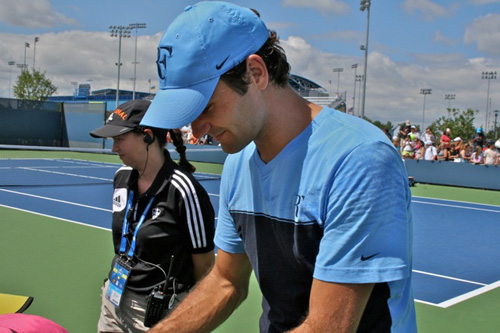 Roger signing hats