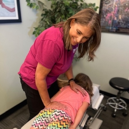 chiropractor adjusting childs back