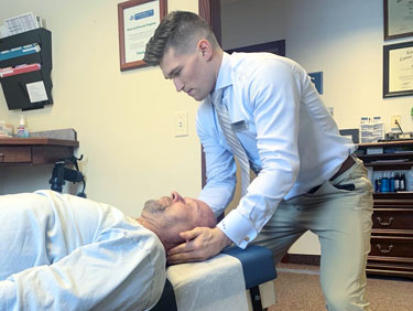 doctor adjusting patient