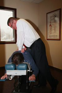 Dr. Goss giving a patient an adjustment