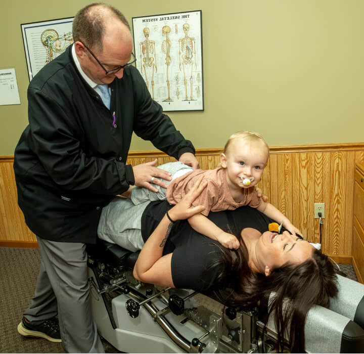 Chiropractor adjusting toddler