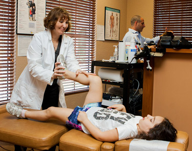 Chiropractor adjusting young girl