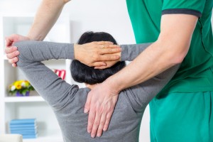 chiropractor adjusting patient