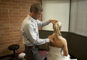 chiropractor checking woman for subluxations