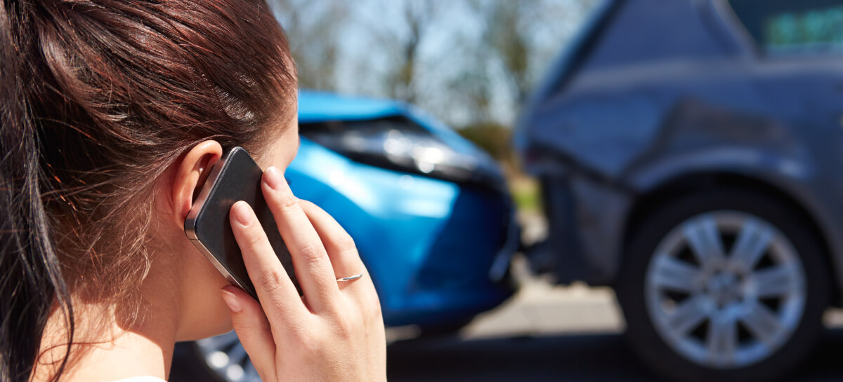 Woman on phone after car accident