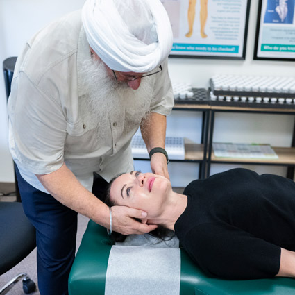 woman having neck adjusted by chiropractor