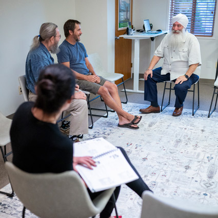 Dr. Khalsa speaking with patients in the waiting room