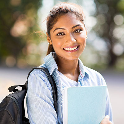 person wearing backpack and smiling