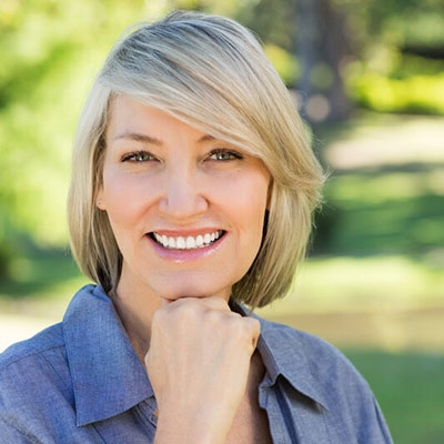 smiling person standing outside