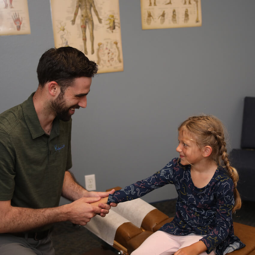 girl having her wrist adjusted