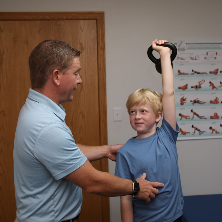 kid doing exercises with our chiropractor
