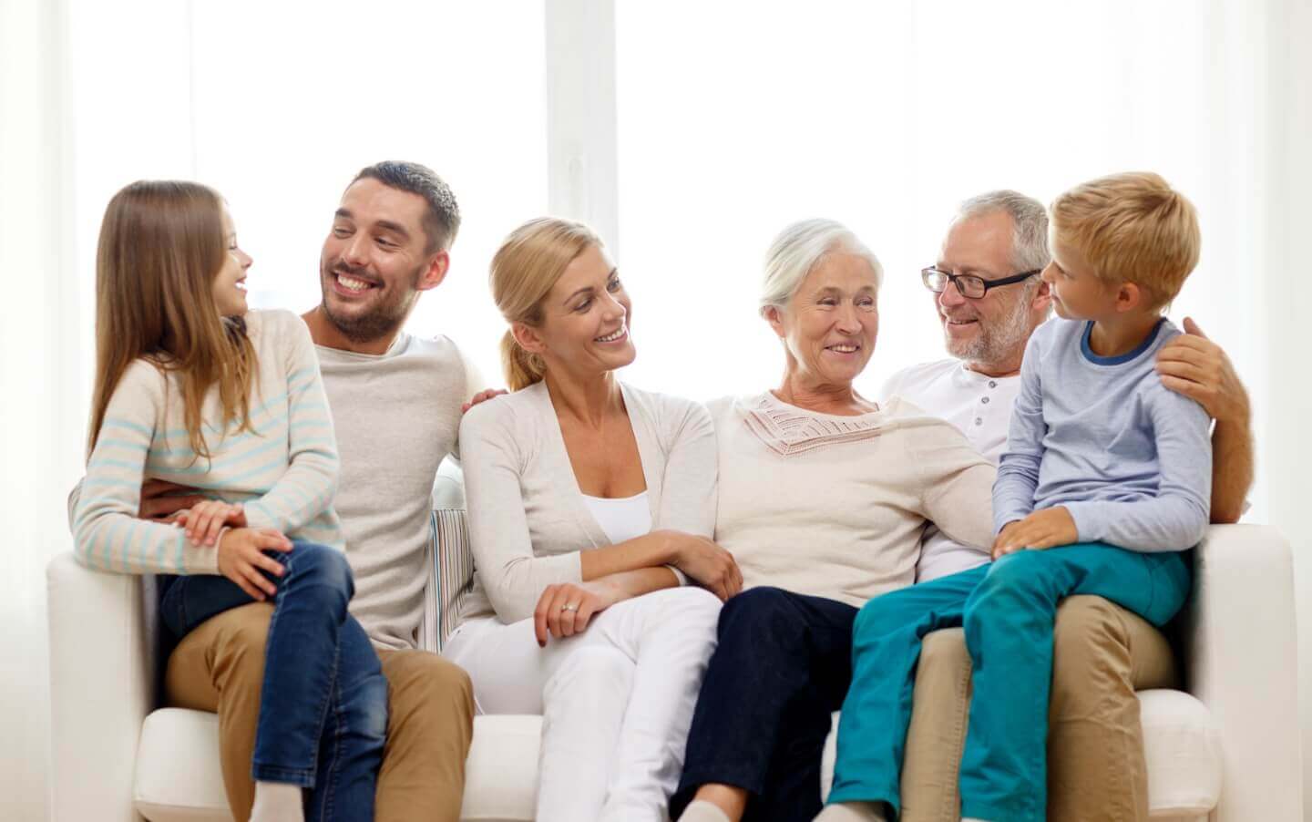 Smiling family sitting on a couch