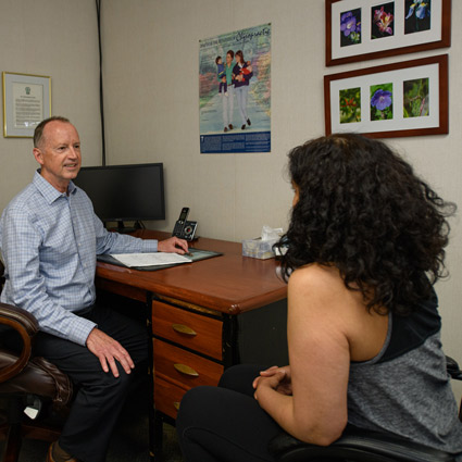 Dr. David Egan speaking with patient in his office