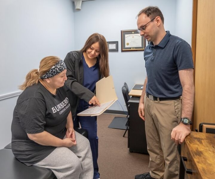 our Muller Chiropractic team talking with a patient