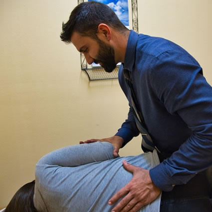 chiropractor adjusting persons back