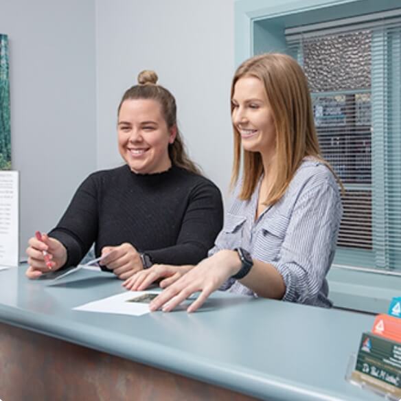 women at reception desk