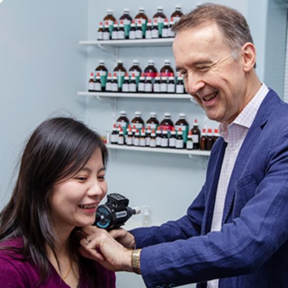 Dr Paul using adjusting tool on patient