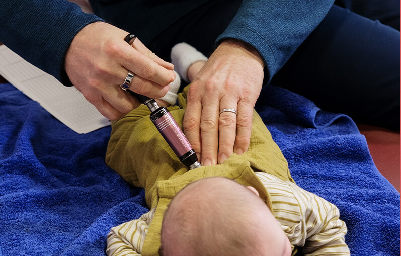 Dr Bates adjusting baby