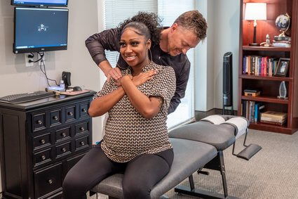 Dr. Matt adjusting pregnant woman