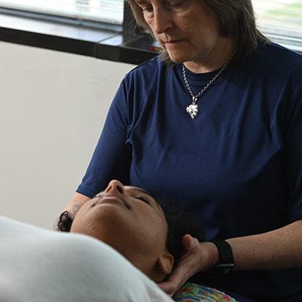 Dr Jackie adjusting practice members neck