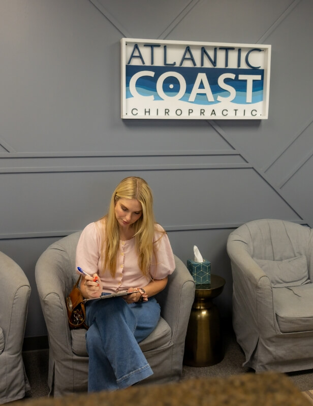 Female patient sitting in Atlantic Coast Chiropractic's waiting room