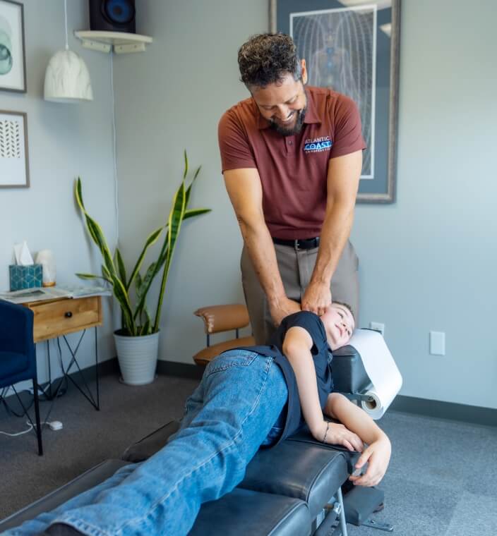 Virginia Beach chiropractor Dr. Green adjusting a patient's neck