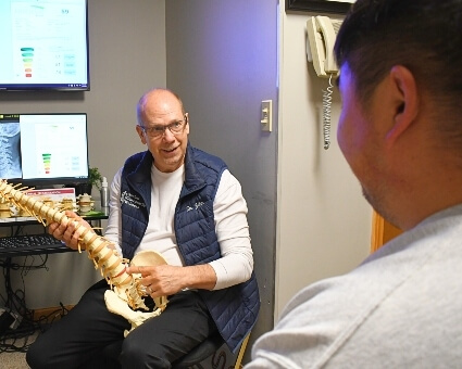 Dr. Goebel holding spine model