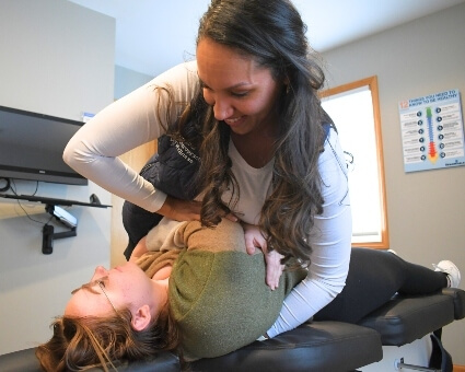 Dr. Tatiana adjusts female patient