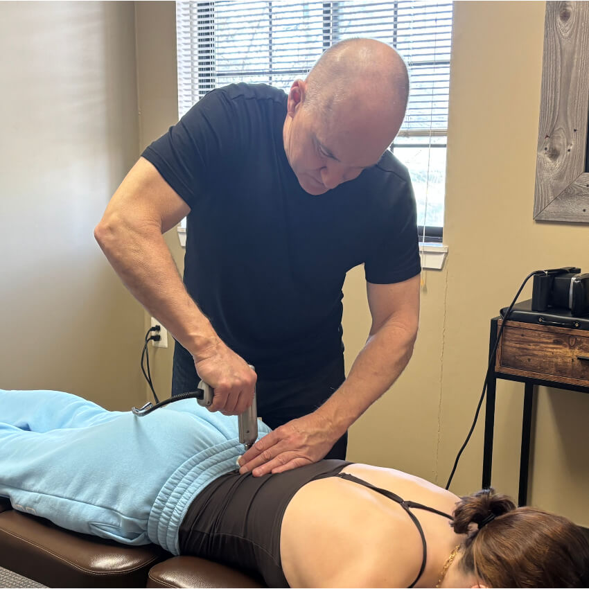 patient having back adjusted with tool