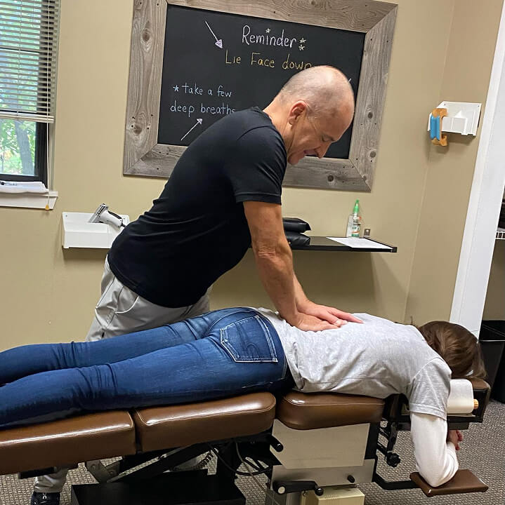 Chiropractor adjusting patient