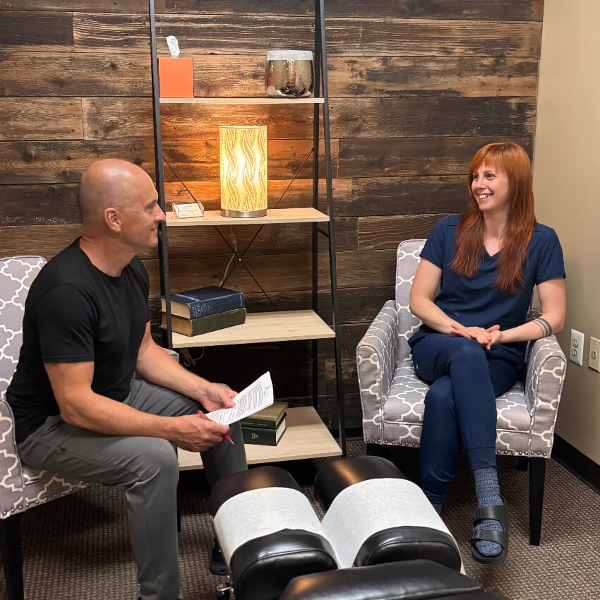 Commerce Township chiropractor talking with a patient