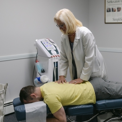 Woodbury chiropractor Dr Cheri adjusting patients back