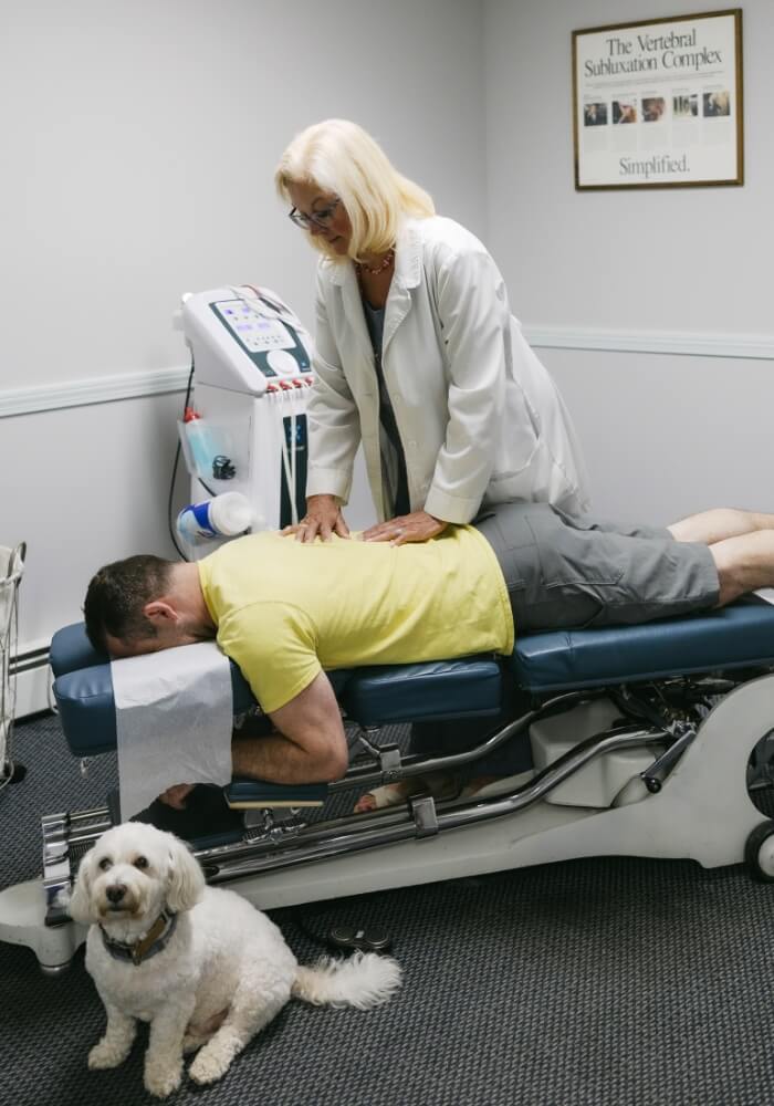 Woodbury chiropractor adjusting patients back