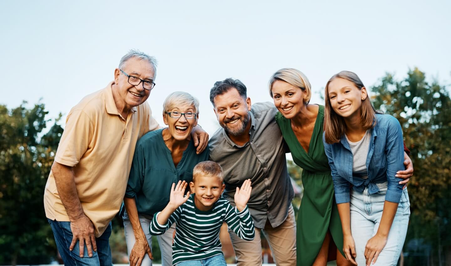 multigenerational famiyl hugging and smiling together