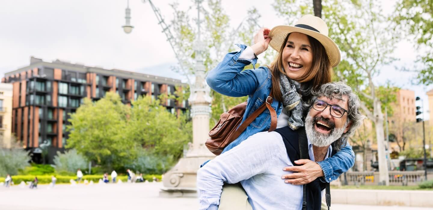 two adults smiling while outdoors
