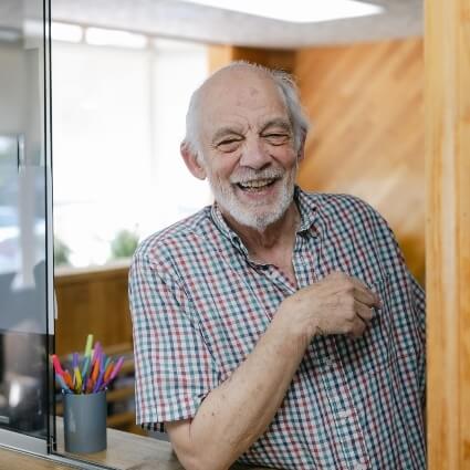 man smiling at check in desk