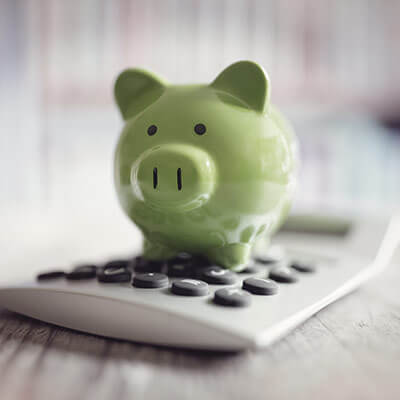 green piggy bank and calculator