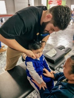 Dr. Alex Morrow adjusting a child