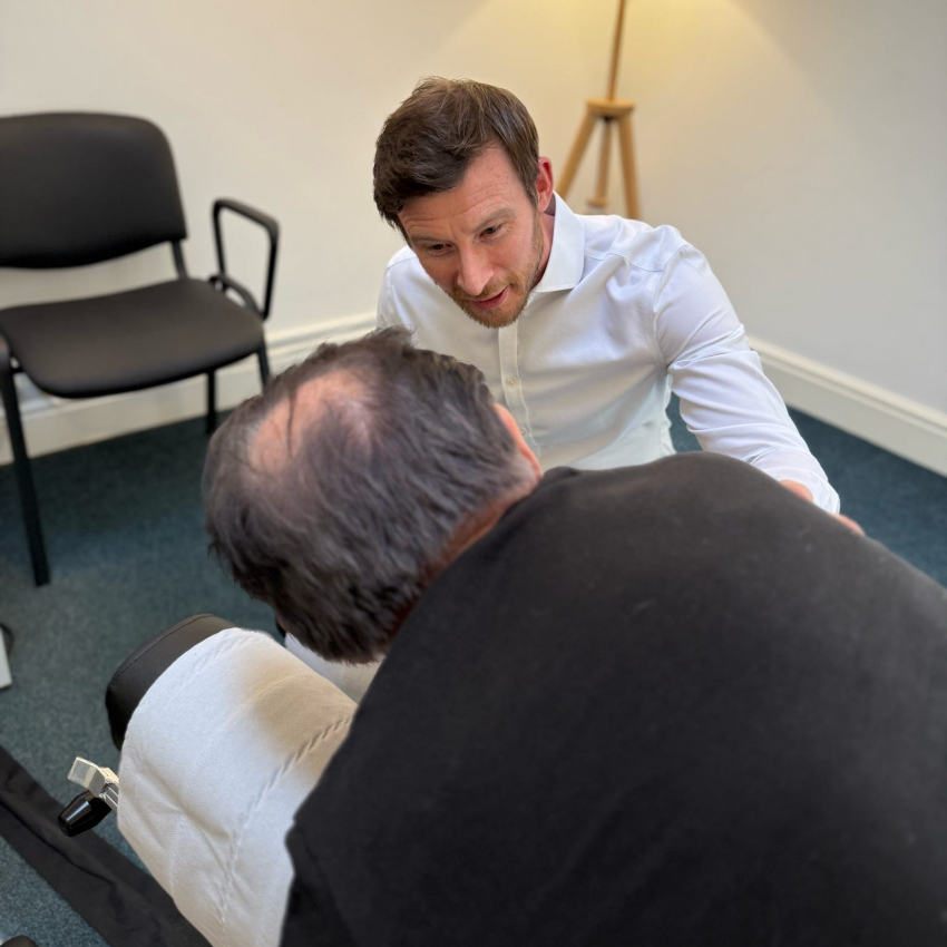 Henley on Thames chiropractor Dr Manning talking to patient