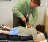A young patient receiving his adjustment with the ArthroStim.
