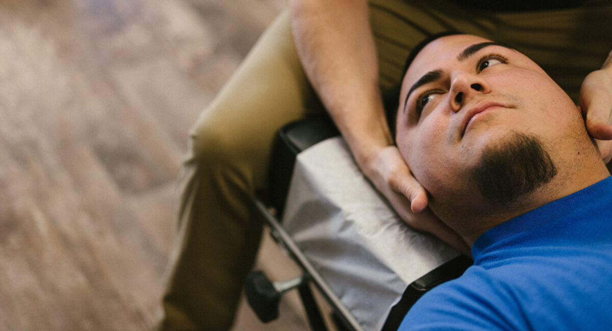 Male patient treated with chiropractic neck adjustment