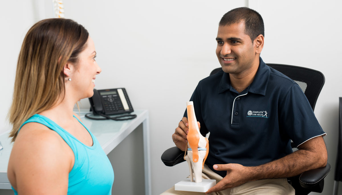 doctor holding spine model