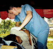 Dr. Wood performs an adjustment on the lower back of a woman in Nepal. The woman had been stooped forward transplanting rice by hand for 10 hours that day. Ouch!
