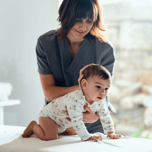 Chiropractor adjusting a baby