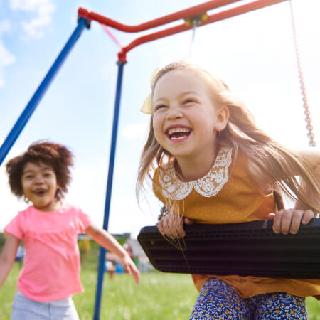 Young girls playing on a swing