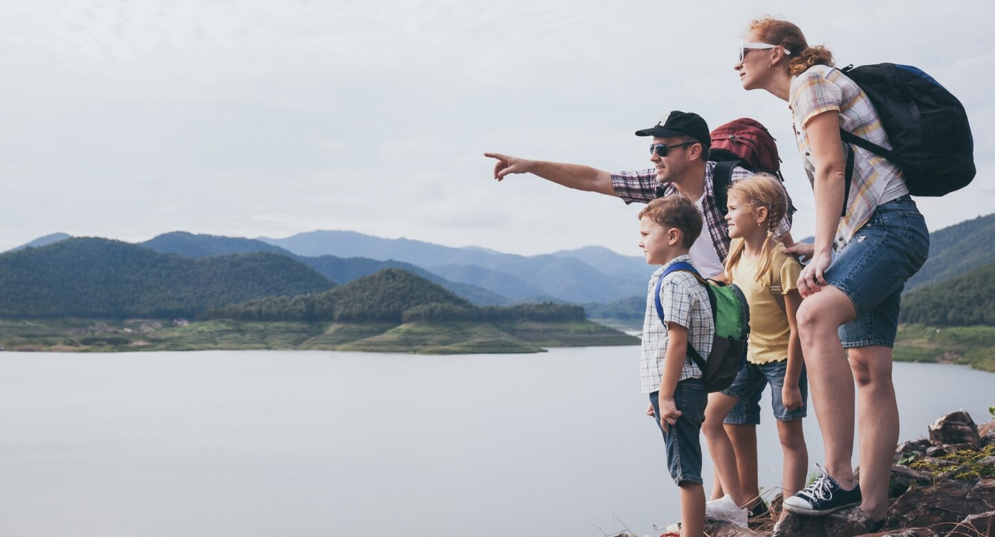 Family of four at a lake