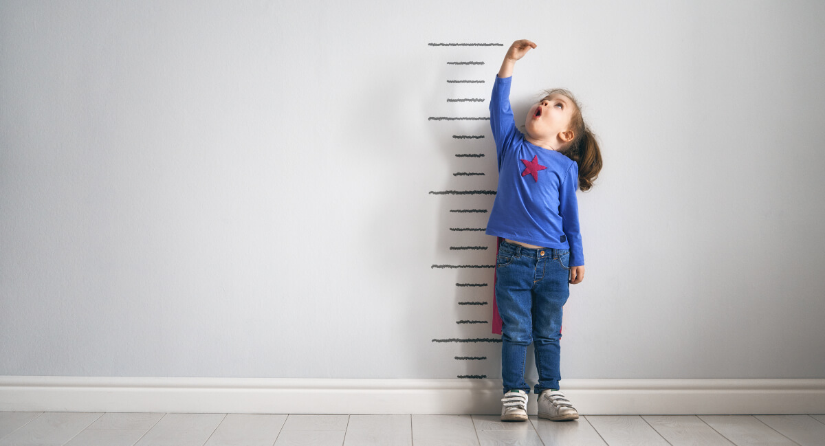 Little girl checking her height