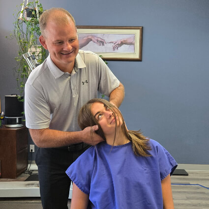 Prince George patient receiving a chiropractic neck adjustment